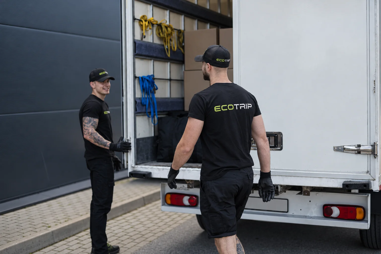 Two EcoTrip team members talking beside an open goods vehicle